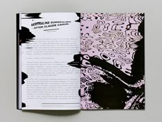 an open book with black and pink designs on it