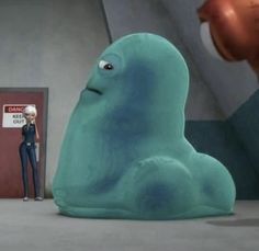 an animated character standing next to a giant blue creature