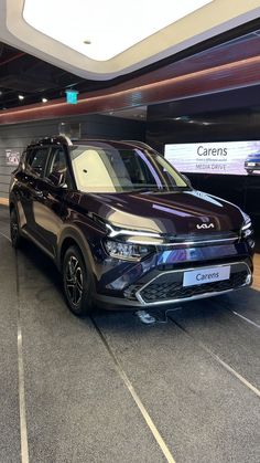 a dark colored car is parked in an empty parking lot with no people around it
