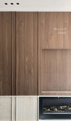 the fireplace is built into the wall with wood paneling on top and below it