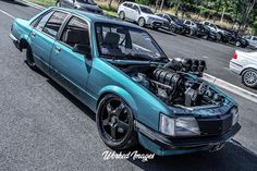 a blue car with an engine in the hood