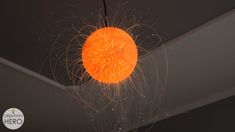 an orange light hanging from the ceiling in a room