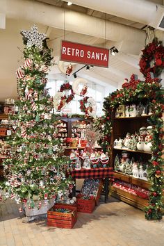 christmas trees and other holiday decorations in a store