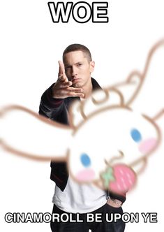 a man pointing at the camera while wearing a white t - shirt and black jacket