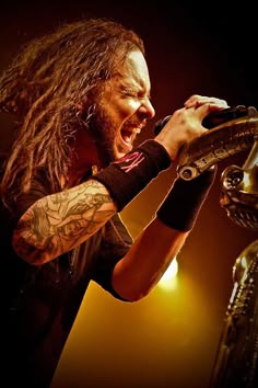 a man with long hair holding a microphone