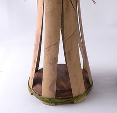 a vase filled with flowers sitting on top of a wooden stand