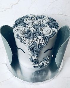 a white and gray cake with flowers on it