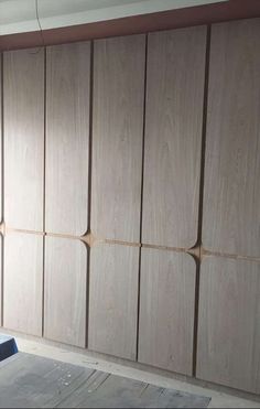 an empty room with several wooden closets in it