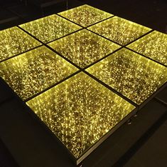 a lighted dance floor in the middle of a room