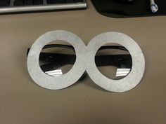 two circular metal objects sitting on top of a desk next to a keyboard and mouse