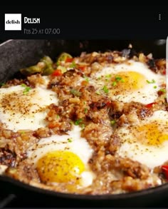 an egg frying in a skillet on top of a stove with other food items