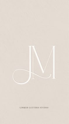 the letter m is shown in white on a beige background with an elegant monogram