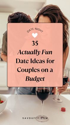 Man with his arm wrapped around a woman in the kitchen while they drink wine and go on a fun date for couples on a budget