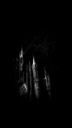 a black and white photo of an old church at night