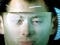 a man is looking at the camera with his eyes wide open while wearing futuristic glasses