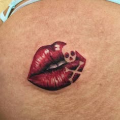 a woman's stomach with a red lip and cross on it