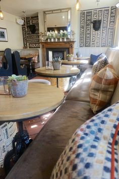a living room filled with furniture and a fire place next to a wall mounted clock