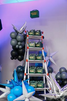 a ladder is set up in front of balloons and other decorations for a birthday party