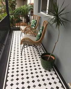 a black and white tiled porch with chairs and a potted plant on the side