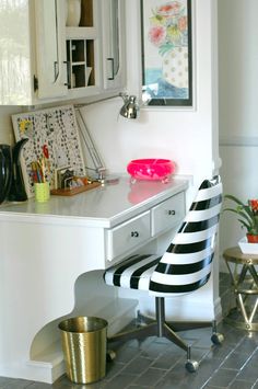 a white desk with a black and white striped chair