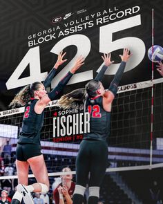 two women are playing volleyball in front of a large sign that says 425 on it
