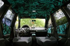 the interior of a vehicle with green and black decor