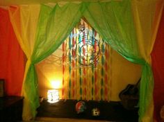 a bed with green curtains and a clock on the wall