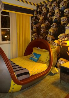 a bedroom decorated in yellow and black with minion wallpaper on the walls behind it