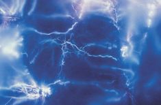 the sky is filled with bright blue and white lightnings as if it were taken from space