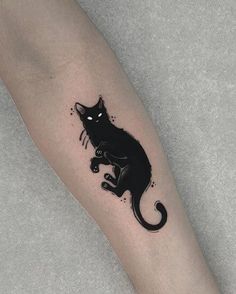 a black cat tattoo on the leg
