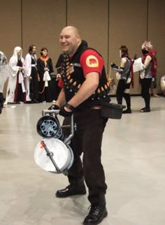a man dressed in costume holding a bike with a helmet on it's back