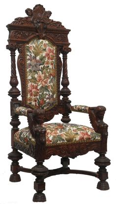 an ornate wooden chair with floral upholstered fabric on the armrests and back