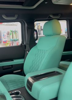 the interior of a vehicle with blue leather seats