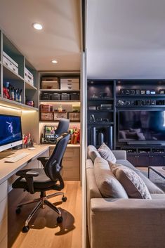 a living room filled with furniture and a flat screen tv on top of a wooden desk