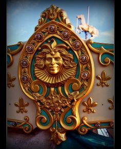 an elaborately decorated horse and carriage with a golden face