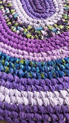 a multicolored round rug is shown on the floor