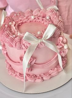 there is a pink cake on the table