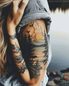 a woman with tattoos on her arm and shoulder is looking down at the water while holding her hand up to her face