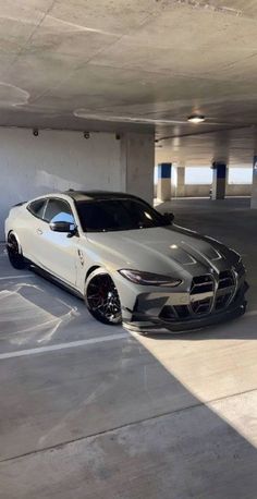 a white sports car parked in a parking garage