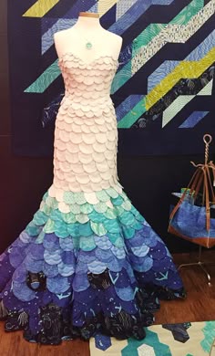 a dress made out of paper on top of a wooden floor