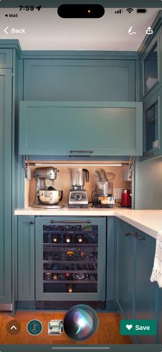 a kitchen with blue cabinets and an appliance