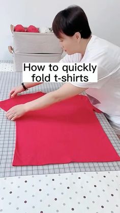 a woman is making a t - shirt out of red material with the words, how to quickly fold t - shirts