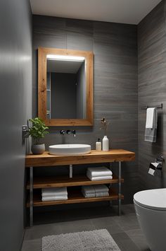 a bathroom with a sink, mirror and toilet