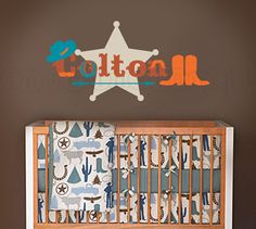 a baby's room with a crib and wall decal that says cotton all