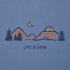 a blue t - shirt with the words life is good written in front of mountains and trees