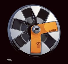 an orange and black wheel cover with the word audi on it's center piece
