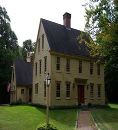 an old house with a lamp post in the front yard