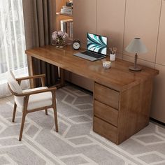 a wooden desk with a laptop on top of it next to a chair and lamp