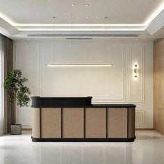 an empty reception room with a plant in the corner