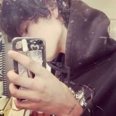 a young man taking a selfie with his cell phone